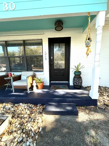 a living room with couch and a large window