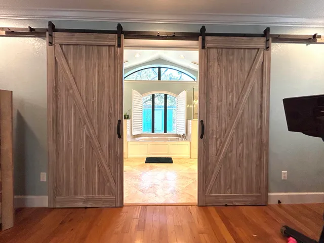 a bathroom with a tub a sink and a large mirror
