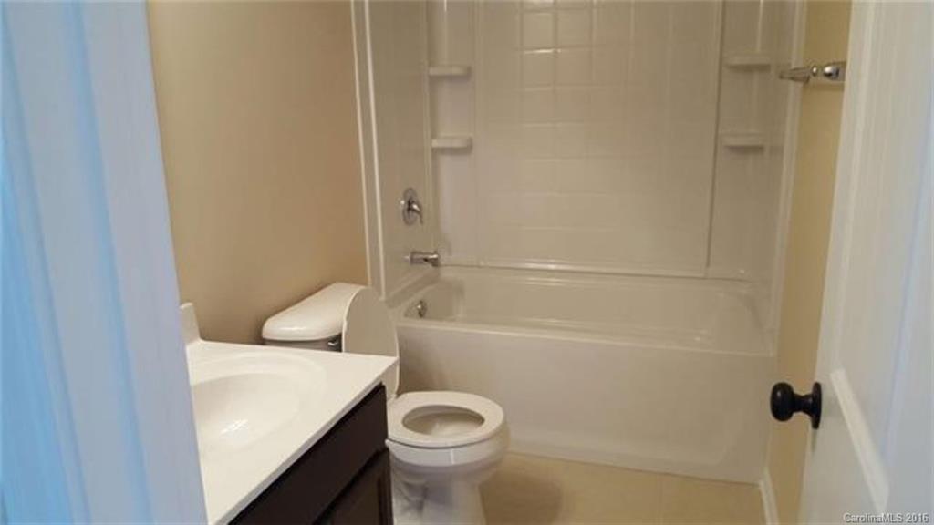 617 School House Lane, Unit 29 Fort Mill, SC 29708 - Photo 12 of 13 a bathroom with a sink a toilet and shower