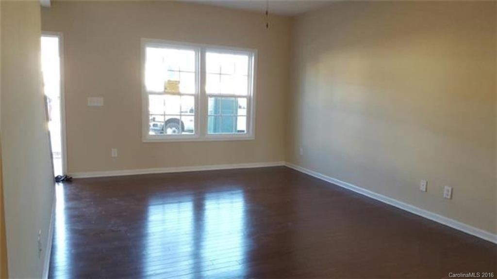 617 School House Lane, Unit 29 Fort Mill, SC 29708 - Photo 3 of 13 an empty room with wooden floor and windows