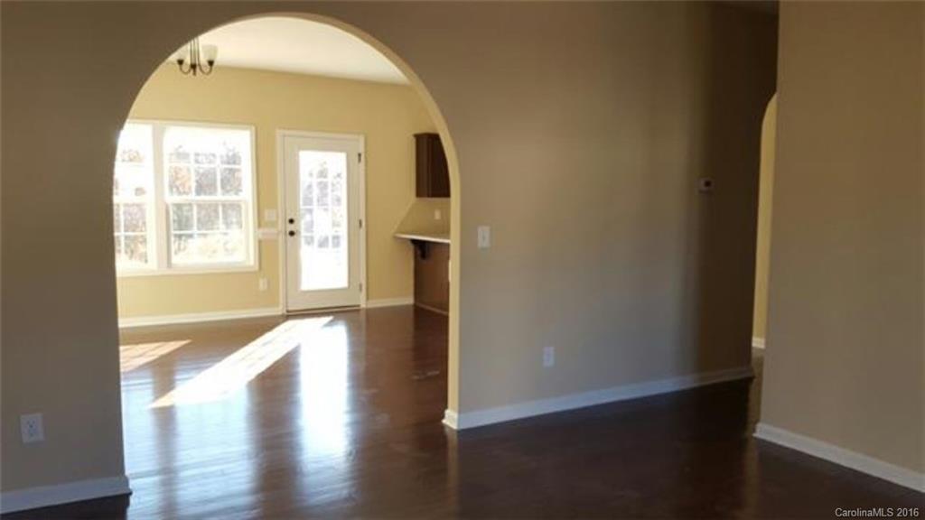 617 School House Lane, Unit 29 Fort Mill, SC 29708 - Photo 4 of 13 an empty room with wooden floor and windows