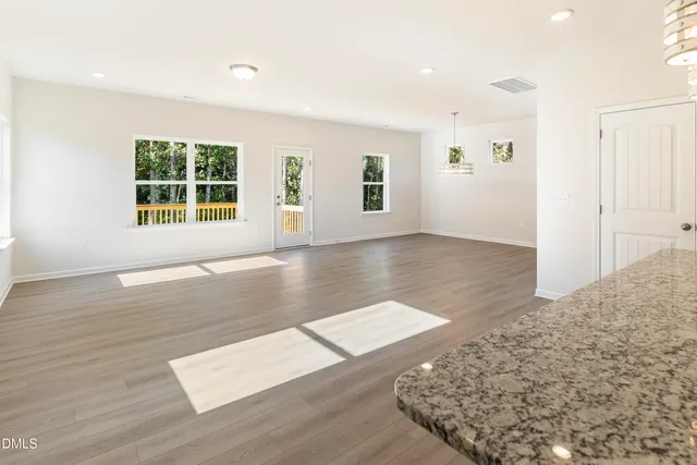 a kitchen with kitchen island granite countertop a sink stove and microwave