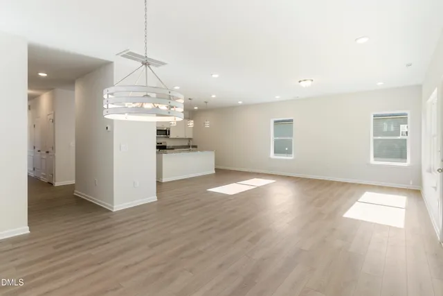 an empty room with a bathroom and a window