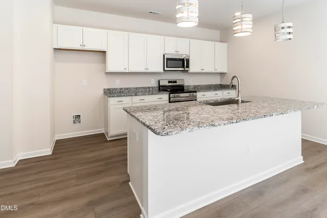 an empty room with wall painting and hallway