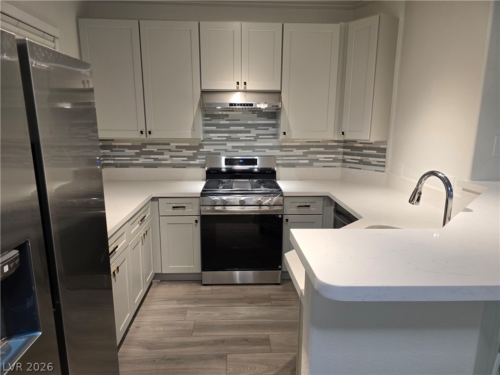 1881 West Alexander Road, Unit 1127 North Las Vegas, NV 89032 - Photo 1 of 20 Modern kitchen with white cabinetry and sleek stainless steel appliances offers both style and functionality.