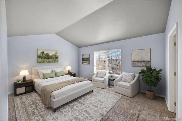 a bedroom with a large bed and a couch