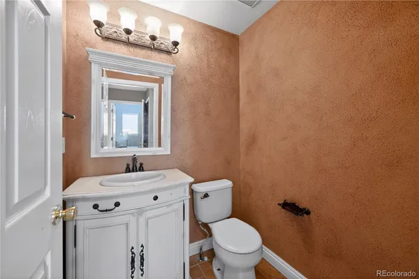 a bathroom with a sink toilet and mirror
