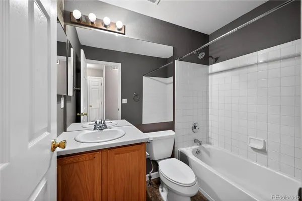 a bathroom with a sink a toilet a mirror and shower