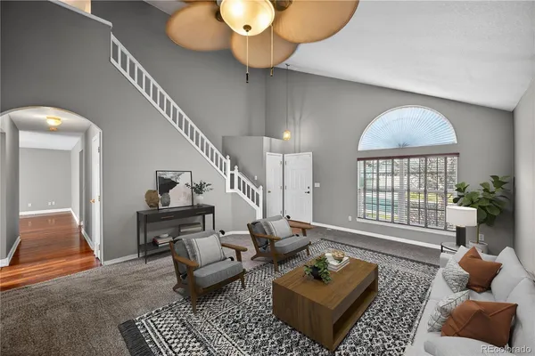 a living room with furniture a rug and a chandelier