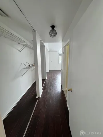 a view of a hallway view with wooden floor and staircase