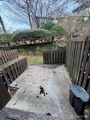 a view of a backyard with sitting area and lake view