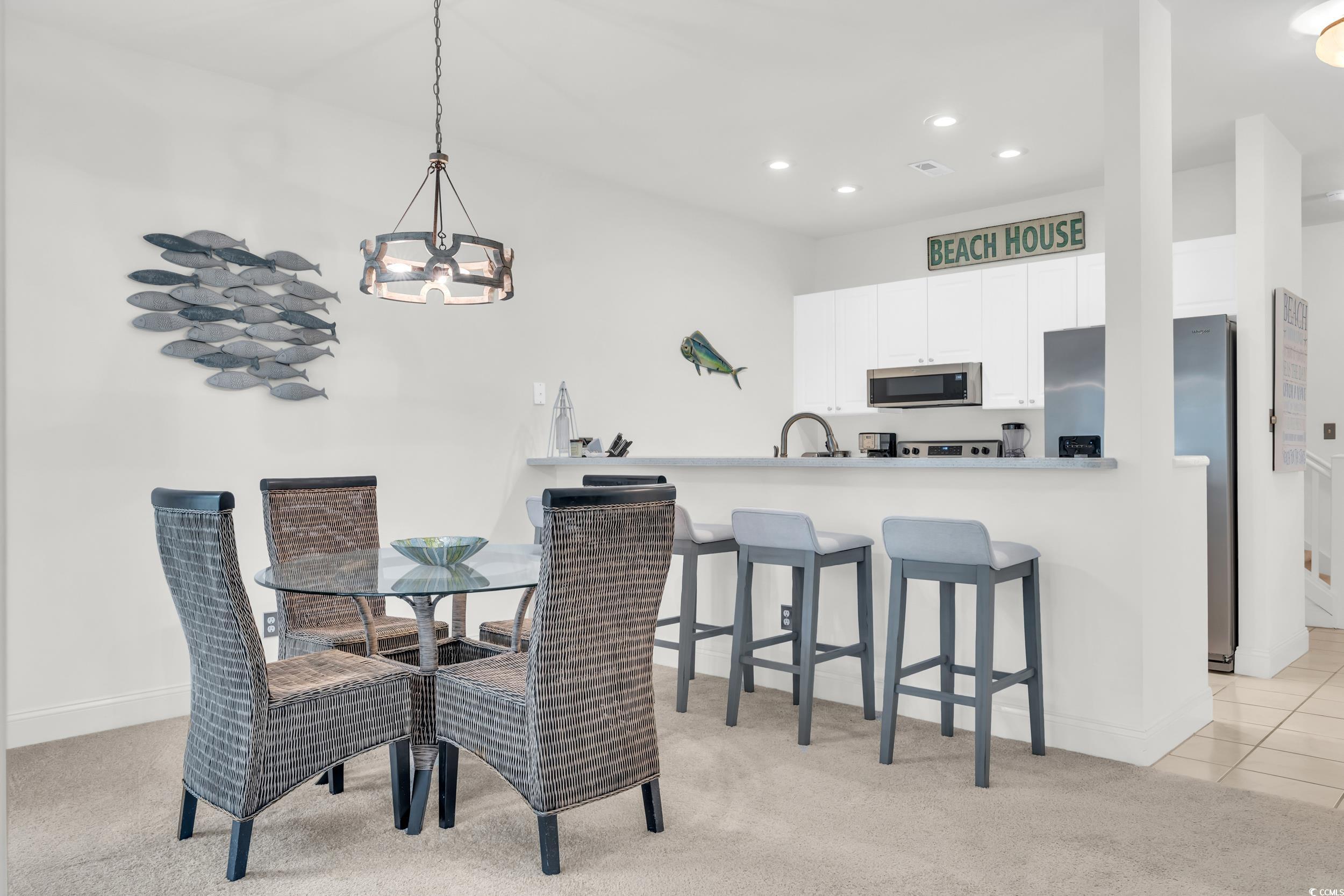141 Twelve Oaks Drive, Unit 5 Pawleys Island, SC 29585 - Photo 12 of 37 Dining room featuring light colored carpet, recessed lighting, a chandelier, and light tile patterned floors