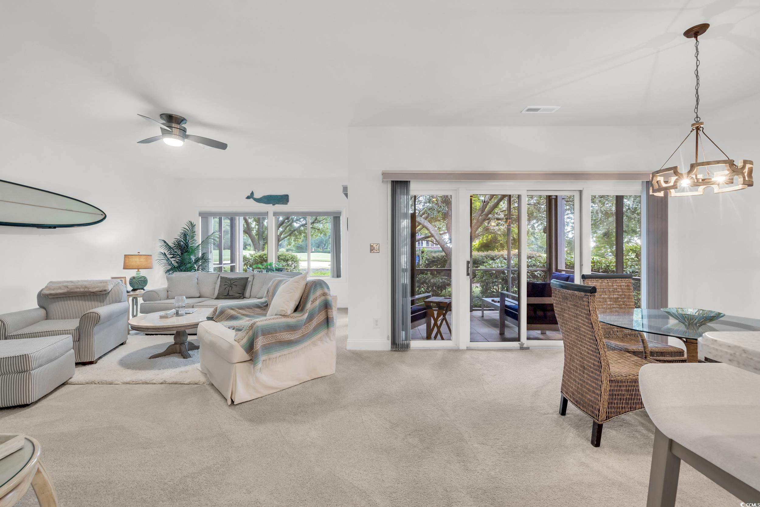 141 Twelve Oaks Drive, Unit 5 Pawleys Island, SC 29585 - Photo 13 of 37 Living room with light colored carpet, a chandelier, and a ceiling fan