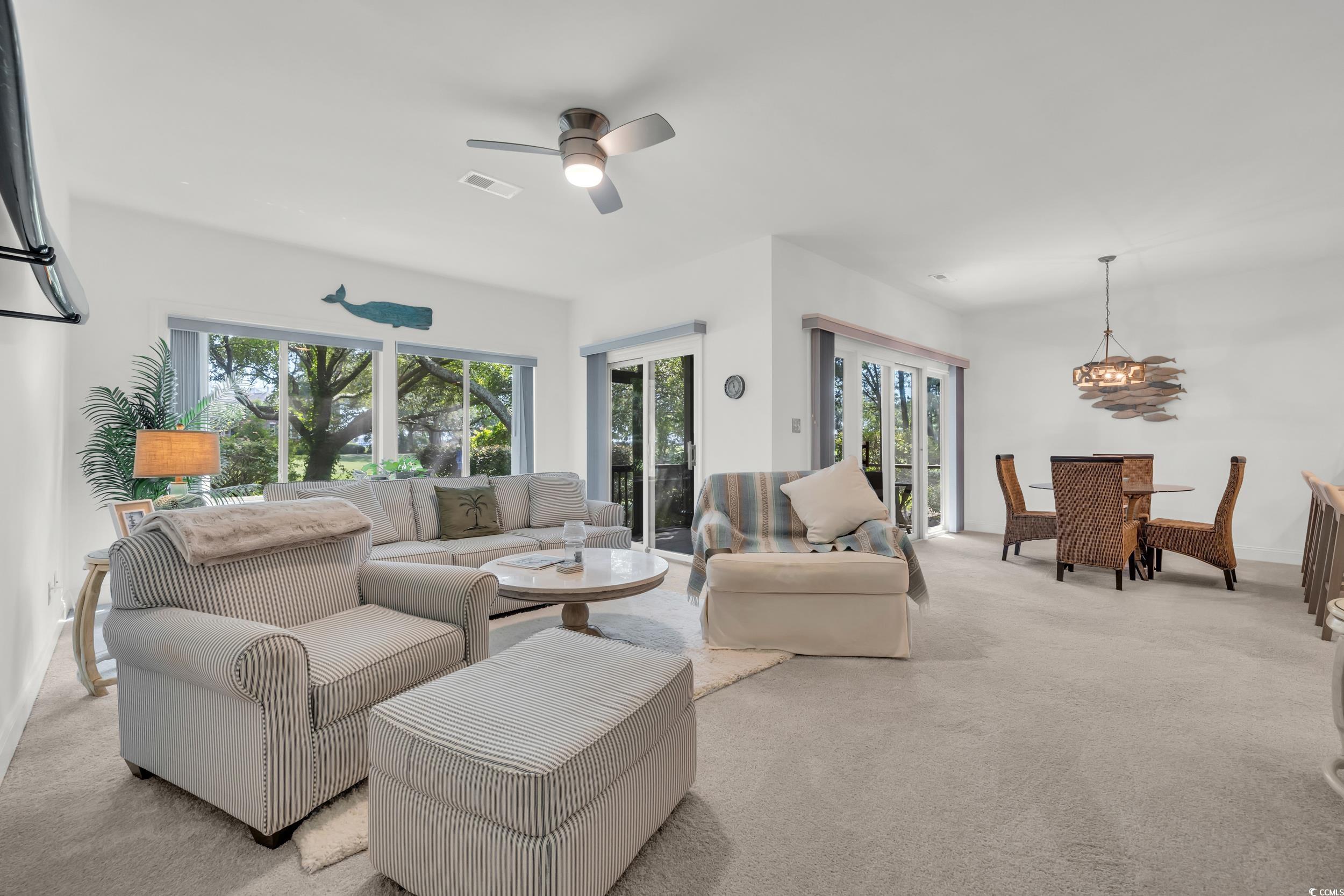 141 Twelve Oaks Drive, Unit 5 Pawleys Island, SC 29585 - Photo 15 of 37 Carpeted living area with ceiling fan and a chandelier