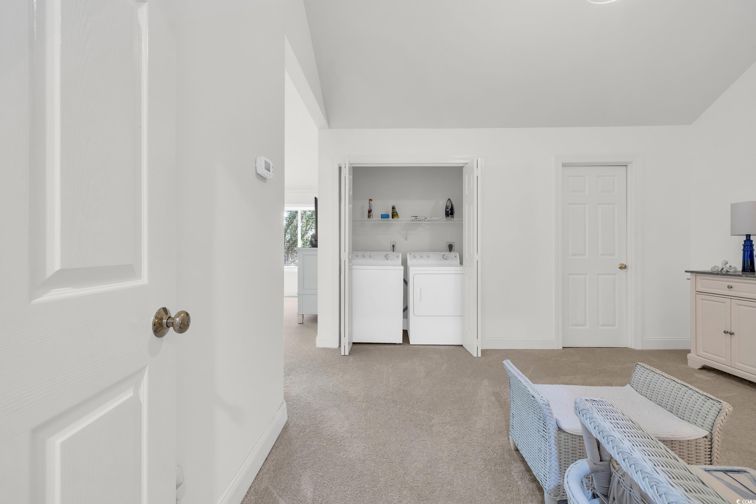 141 Twelve Oaks Drive, Unit 5 Pawleys Island, SC 29585 - Photo 20 of 37 Bedroom featuring light colored carpet and washer and clothes dryer