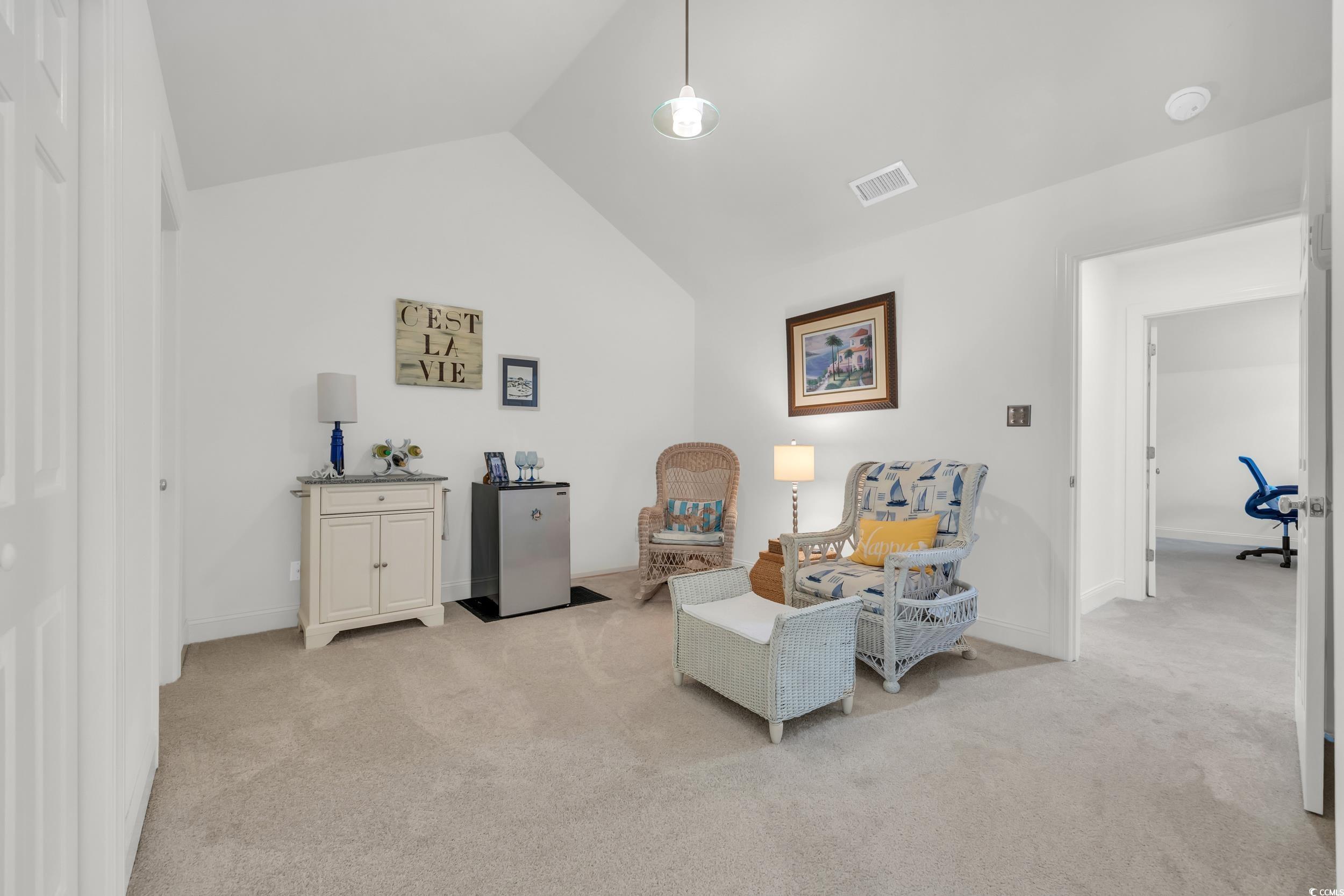 141 Twelve Oaks Drive, Unit 5 Pawleys Island, SC 29585 - Photo 21 of 37 Sitting room featuring vaulted ceiling and light carpet