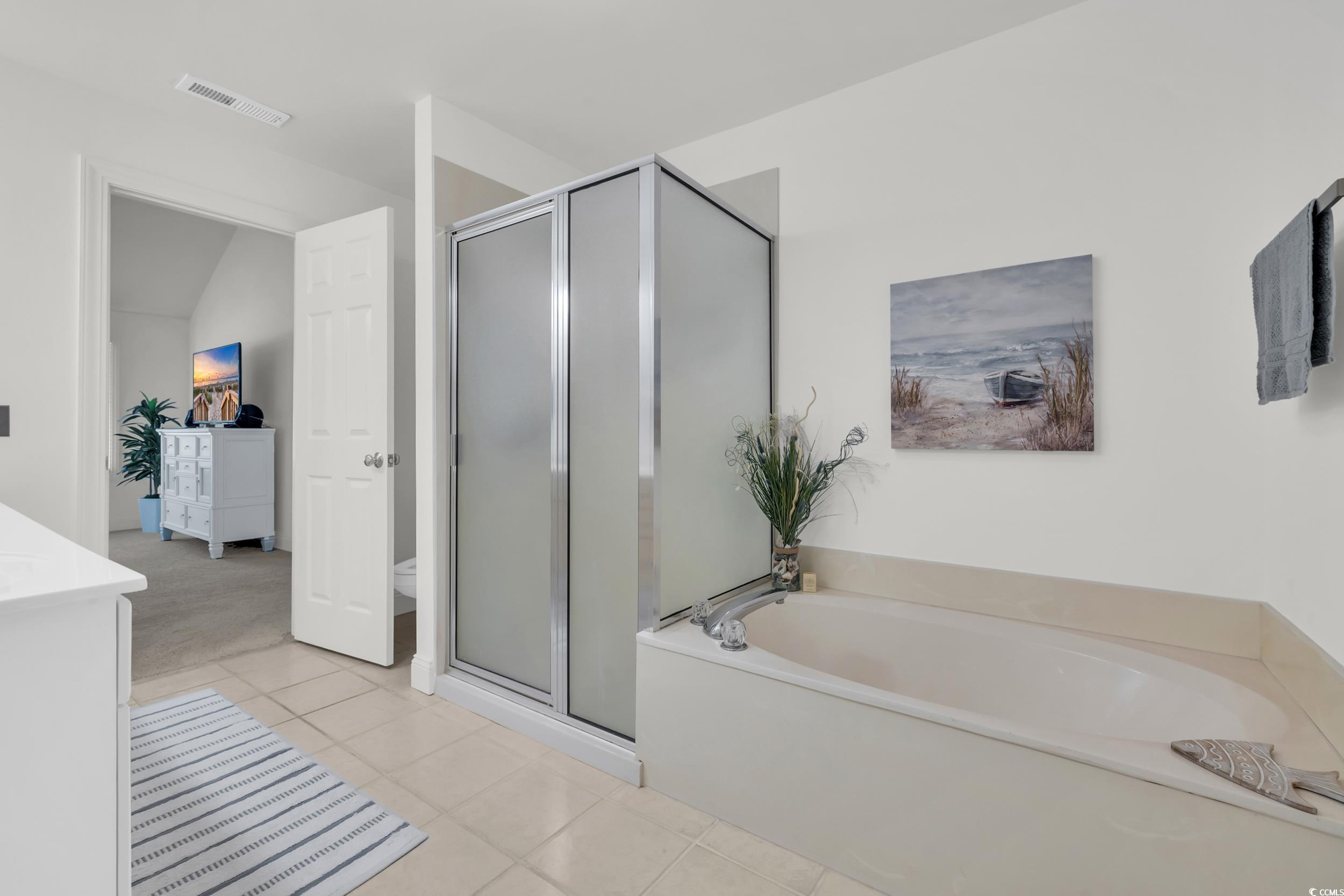 141 Twelve Oaks Drive, Unit 5 Pawleys Island, SC 29585 - Photo 26 of 37 Full bath featuring a bath, a stall shower, light tile patterned floors, and lofted ceiling