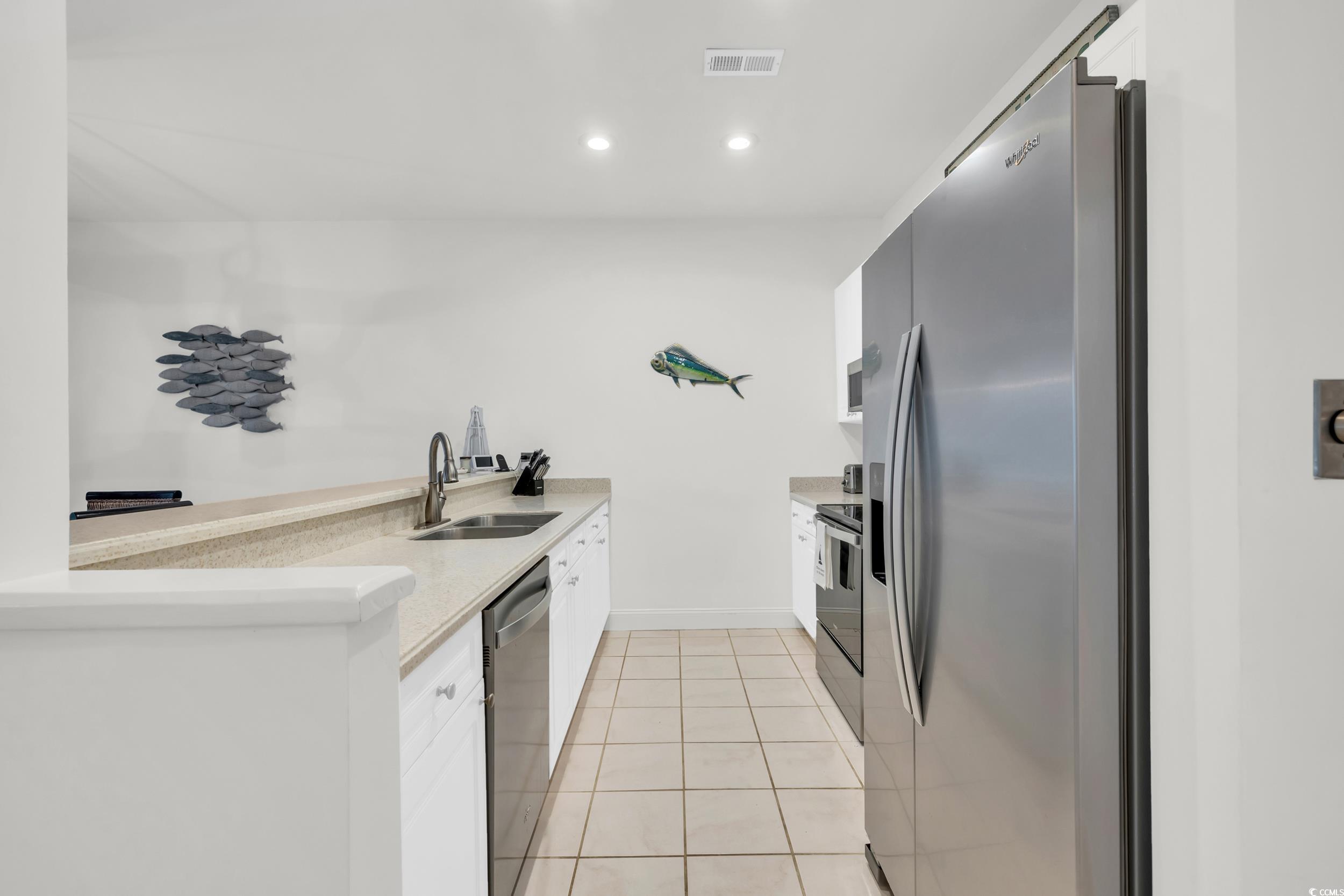 141 Twelve Oaks Drive, Unit 5 Pawleys Island, SC 29585 - Photo 7 of 37 Kitchen with white cabinetry, appliances with stainless steel finishes, light tile patterned floors, a peninsula, and recessed lighting