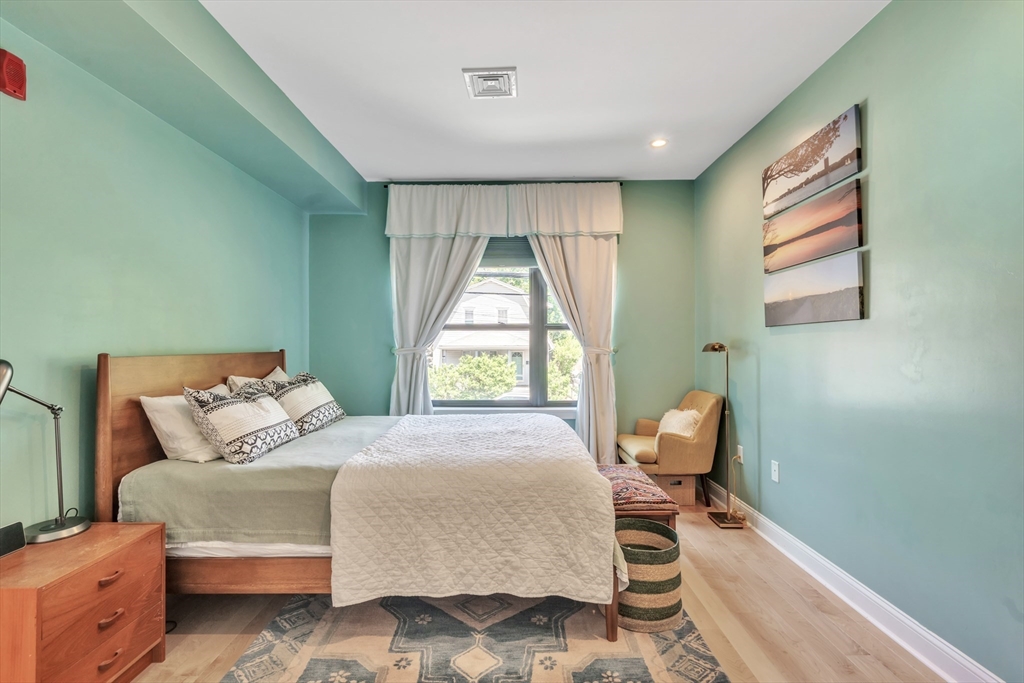 1 Brook Road, Unit 215 Quincy, MA 02169 - Photo 11 of 24 a bedroom with a bed and a window