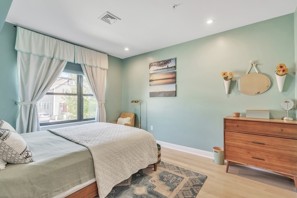 1 Brook Road, Unit 215 Quincy, MA 02169 - Photo 12 of 24 a bedroom with a bed and a window