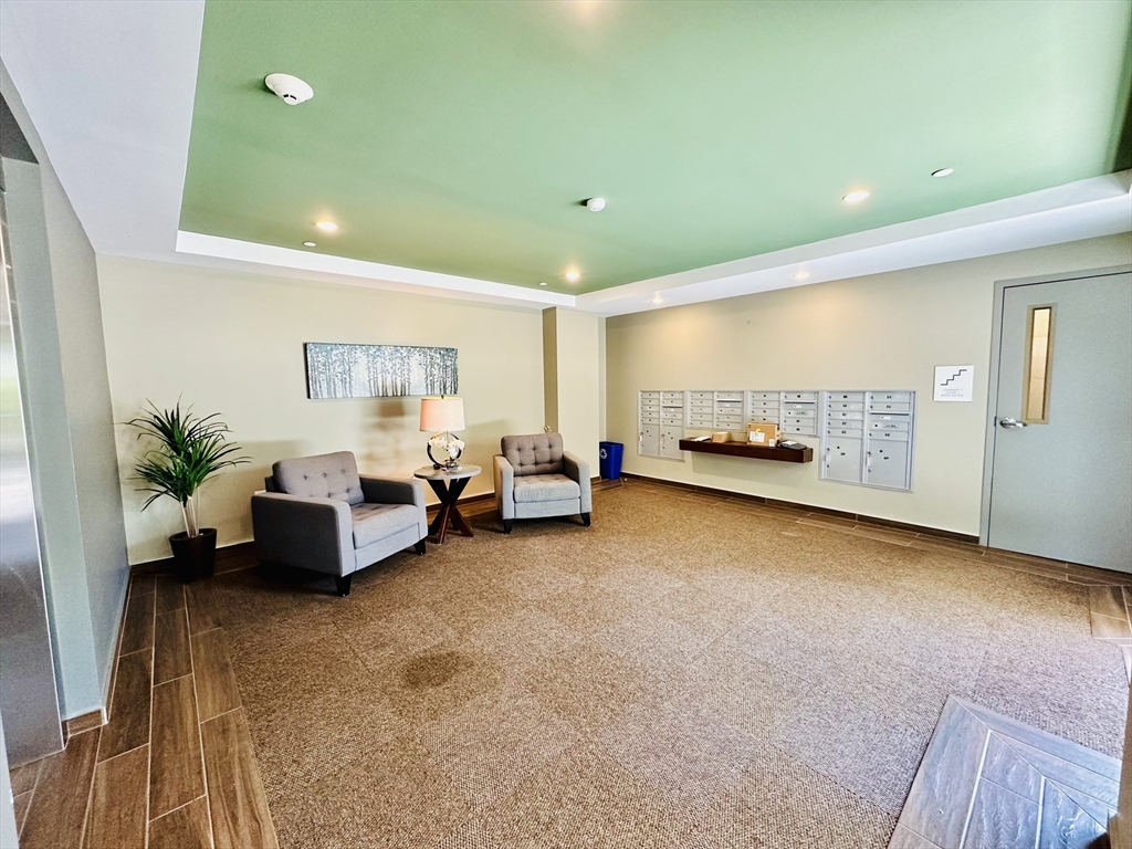1 Brook Road, Unit 215 Quincy, MA 02169 - Photo 17 of 24 a living room with furniture and a couch