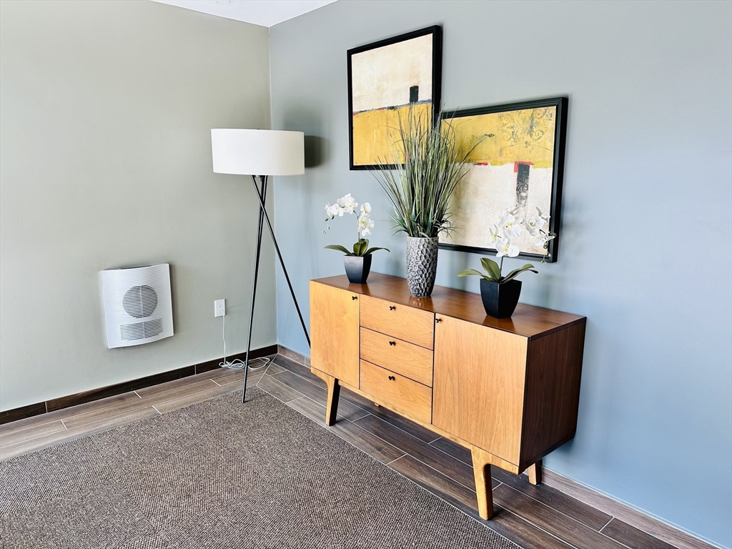 1 Brook Road, Unit 215 Quincy, MA 02169 - Photo 18 of 24 a living room with furniture and a flat screen tv