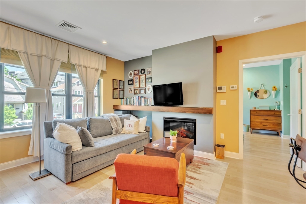 1 Brook Road, Unit 215 Quincy, MA 02169 - Photo 2 of 24 a living room with furniture and a flat screen tv