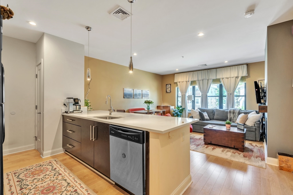1 Brook Road, Unit 215 Quincy, MA 02169 - Photo 5 of 24 a view of a kitchen counter top space a sink a refrigerator and a window