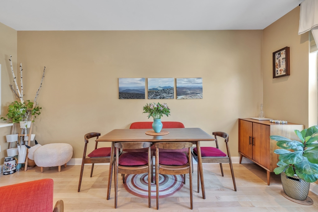 1 Brook Road, Unit 215 Quincy, MA 02169 - Photo 8 of 24 a dining room with furniture and wooden floor