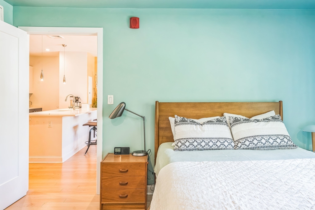 1 Brook Road, Unit 215 Quincy, MA 02169 - Photo 10 of 24 a bedroom with a bed and a dresser