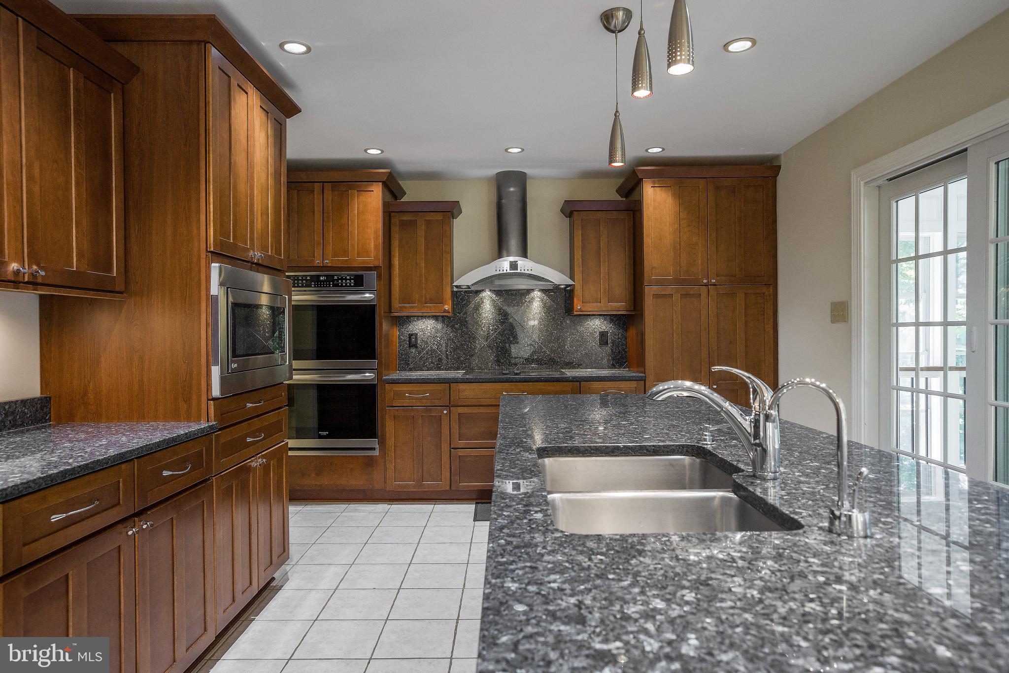 3276 Fox Mill Road Oakton, VA 22124 - Photo 7 of 45 Tile flooring, custom cooktop vent in kitchen