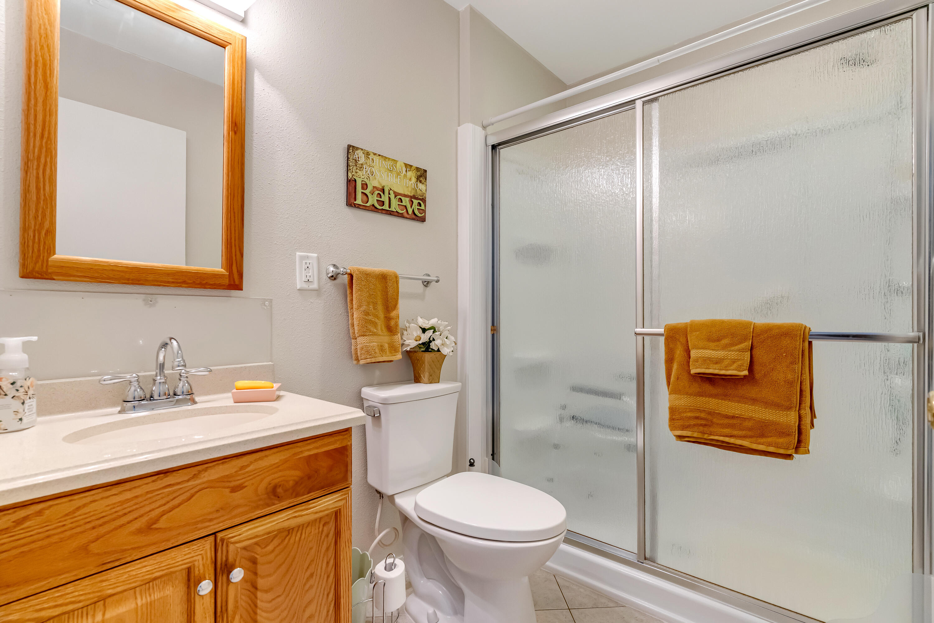 1401 Greenwood Road Baker, FL 32531 - Photo 13 of 61 a bathroom with a toilet sink vanity shower and mirror