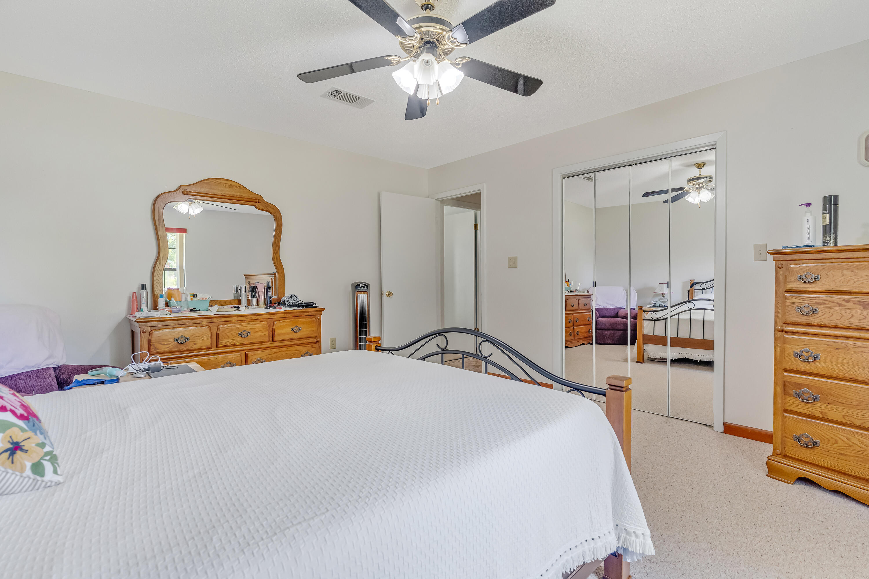 1401 Greenwood Road Baker, FL 32531 - Photo 16 of 61 a bedroom with a bed and a chandelier