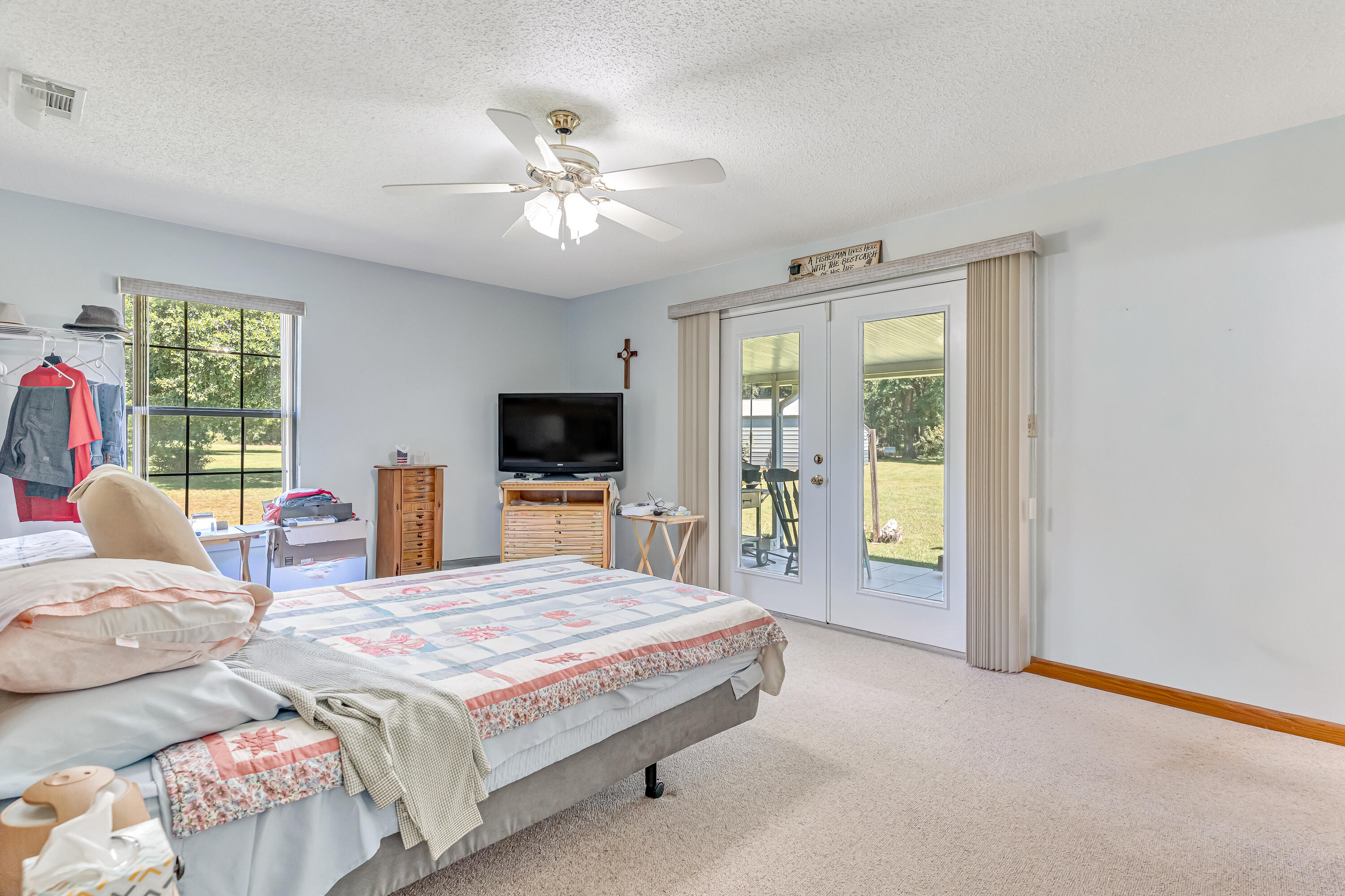 1401 Greenwood Road Baker, FL 32531 - Photo 17 of 61 a bedroom with a bed and a flat screen tv