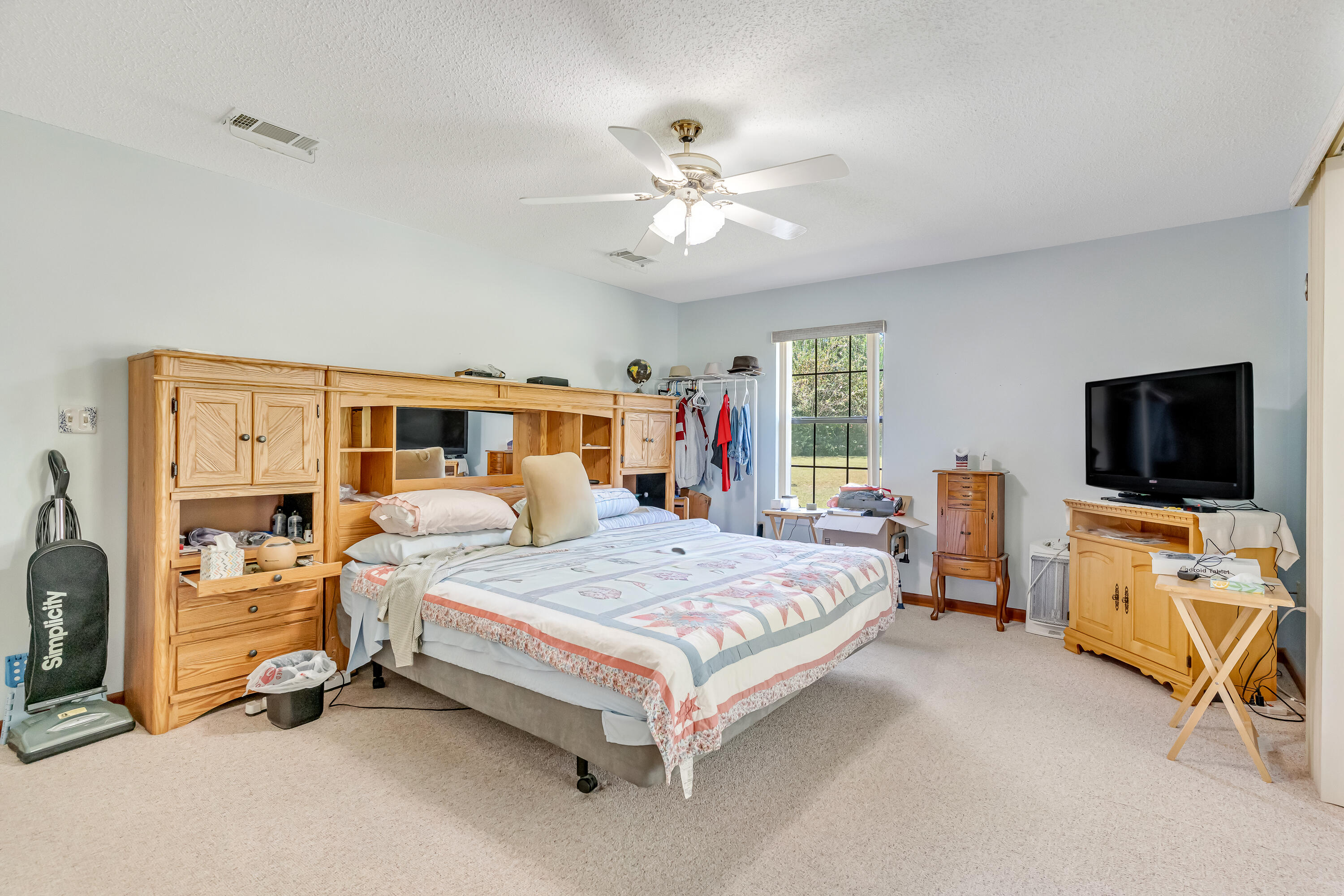 1401 Greenwood Road Baker, FL 32531 - Photo 18 of 61 a bedroom with a bed and a flat screen tv