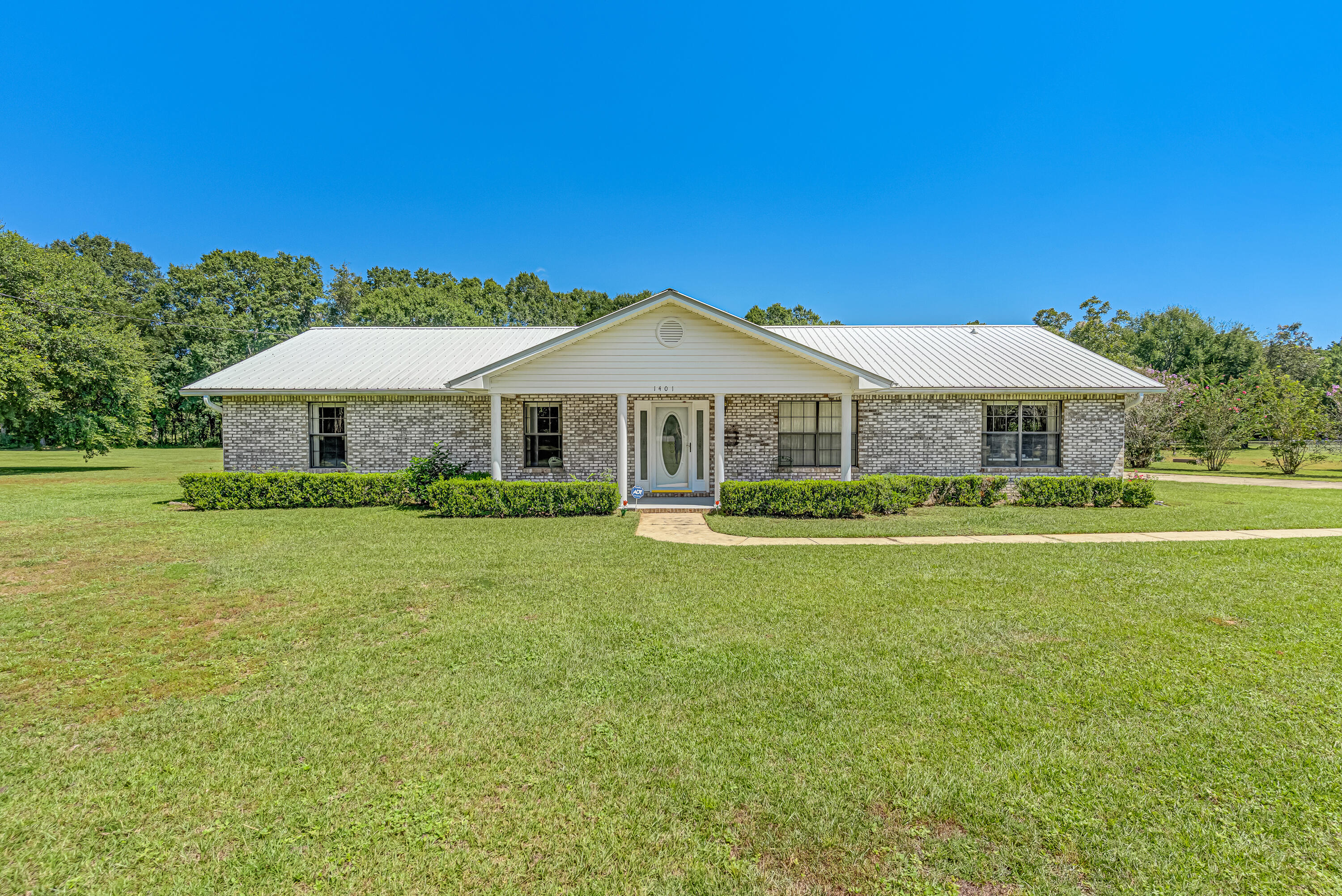 1401 Greenwood Road Baker, FL 32531 - Photo 2 of 61 a front view of a house with a garden