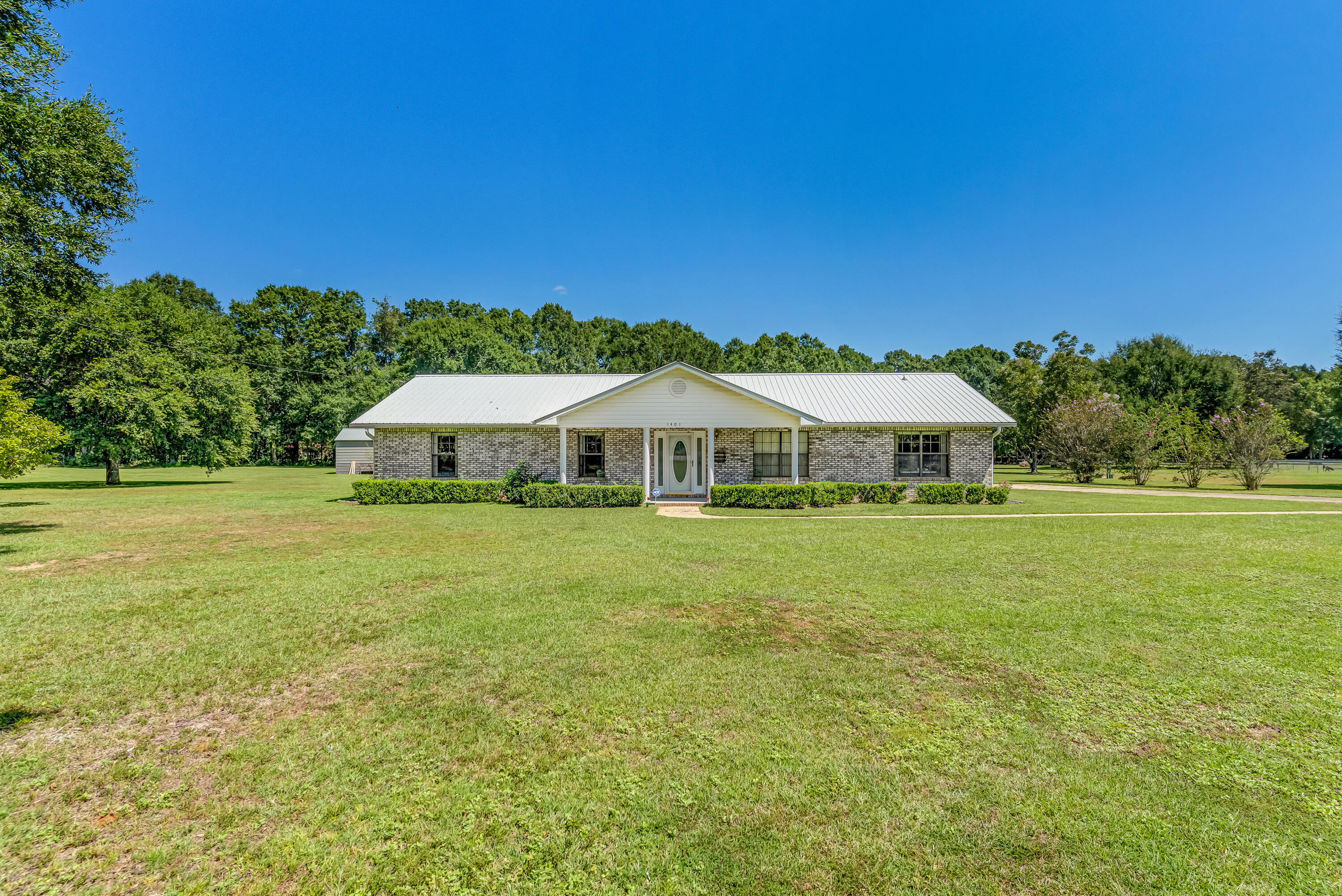 1401 Greenwood Road Baker, FL 32531 - Photo 33 of 61 a aerial view of a house with swimming pool garden view and a lake view