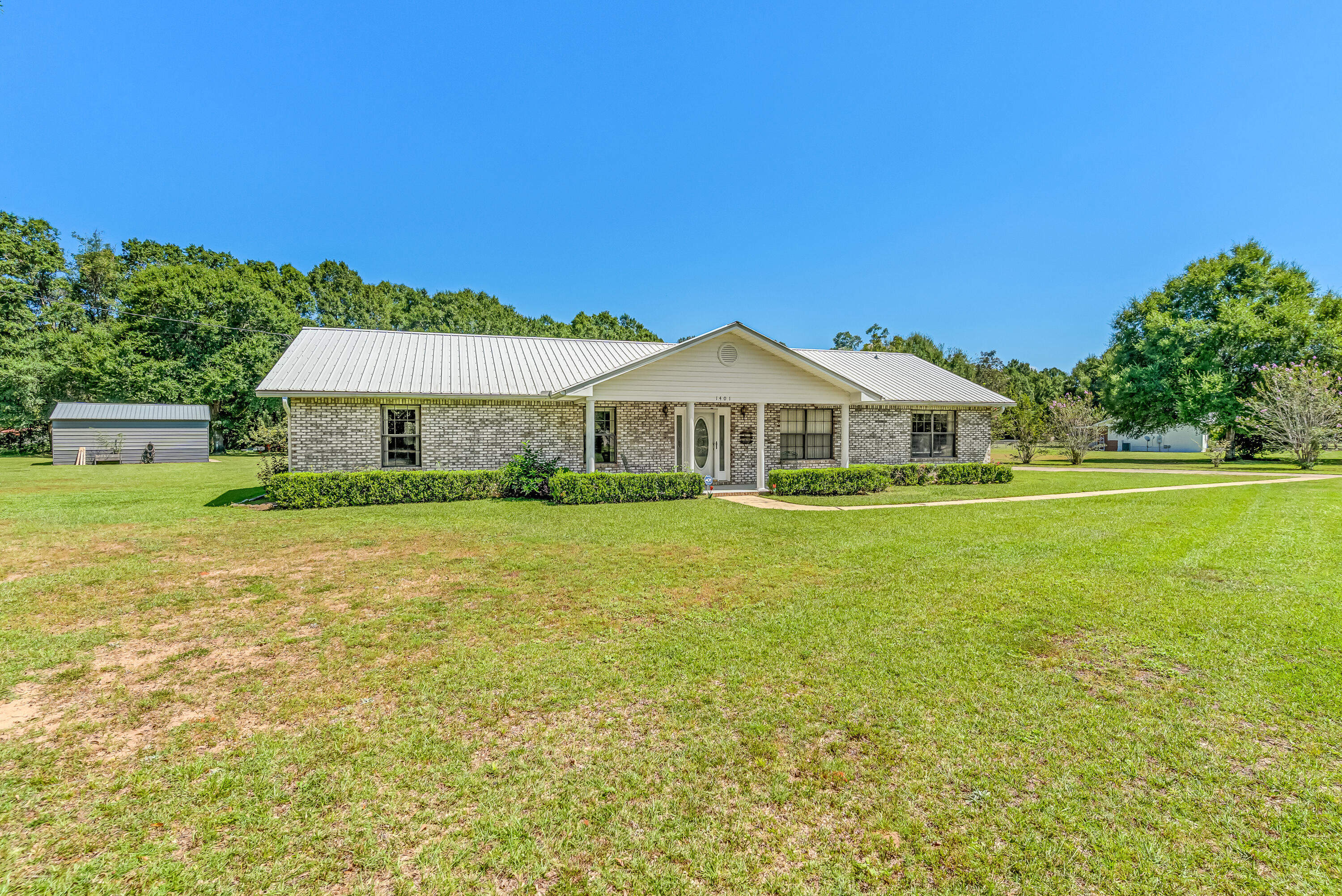 1401 Greenwood Road Baker, FL 32531 - Photo 34 of 61 a front view of a house with yard and green space