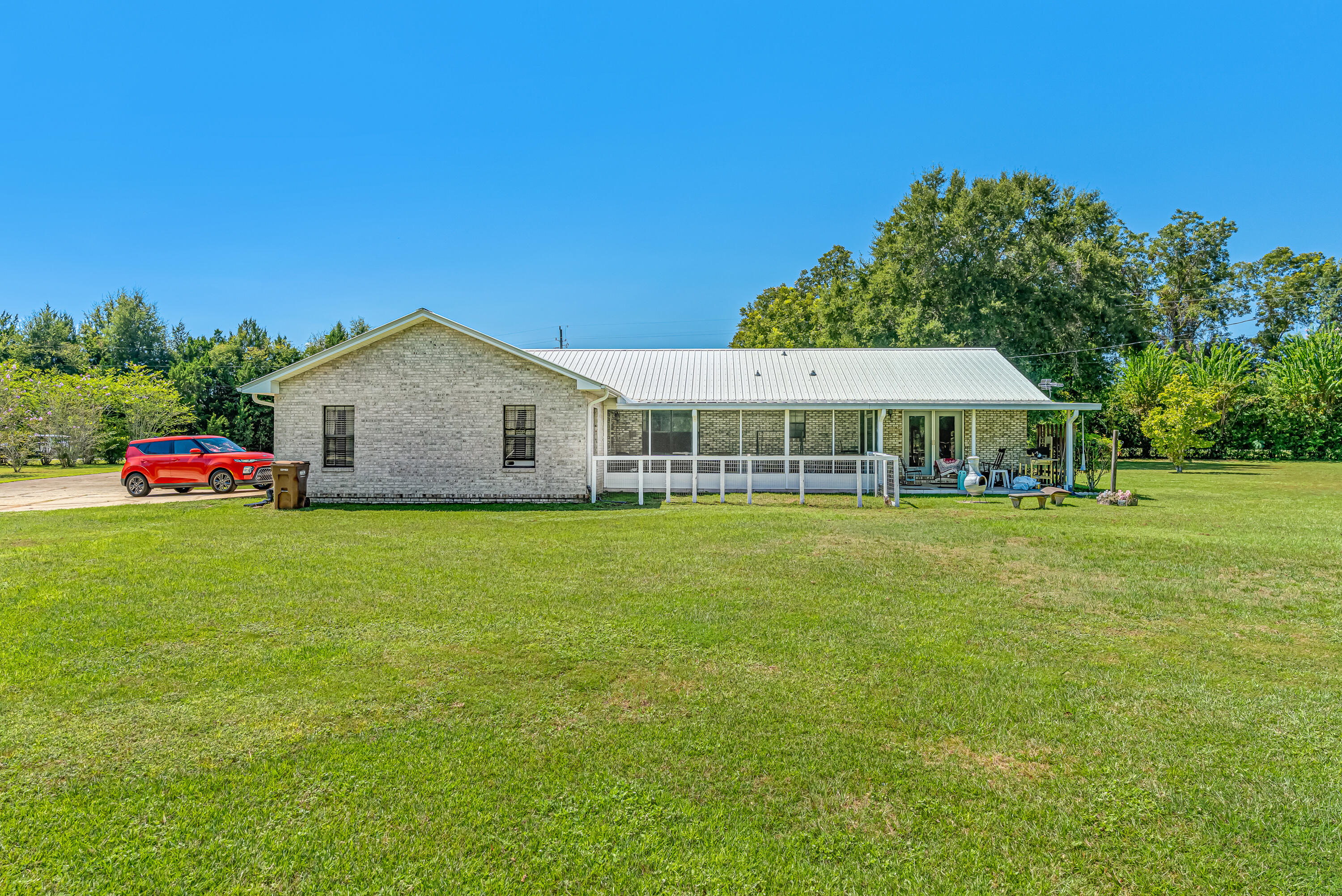 1401 Greenwood Road Baker, FL 32531 - Photo 39 of 61 a front view of house with outdoor space and trees in the background