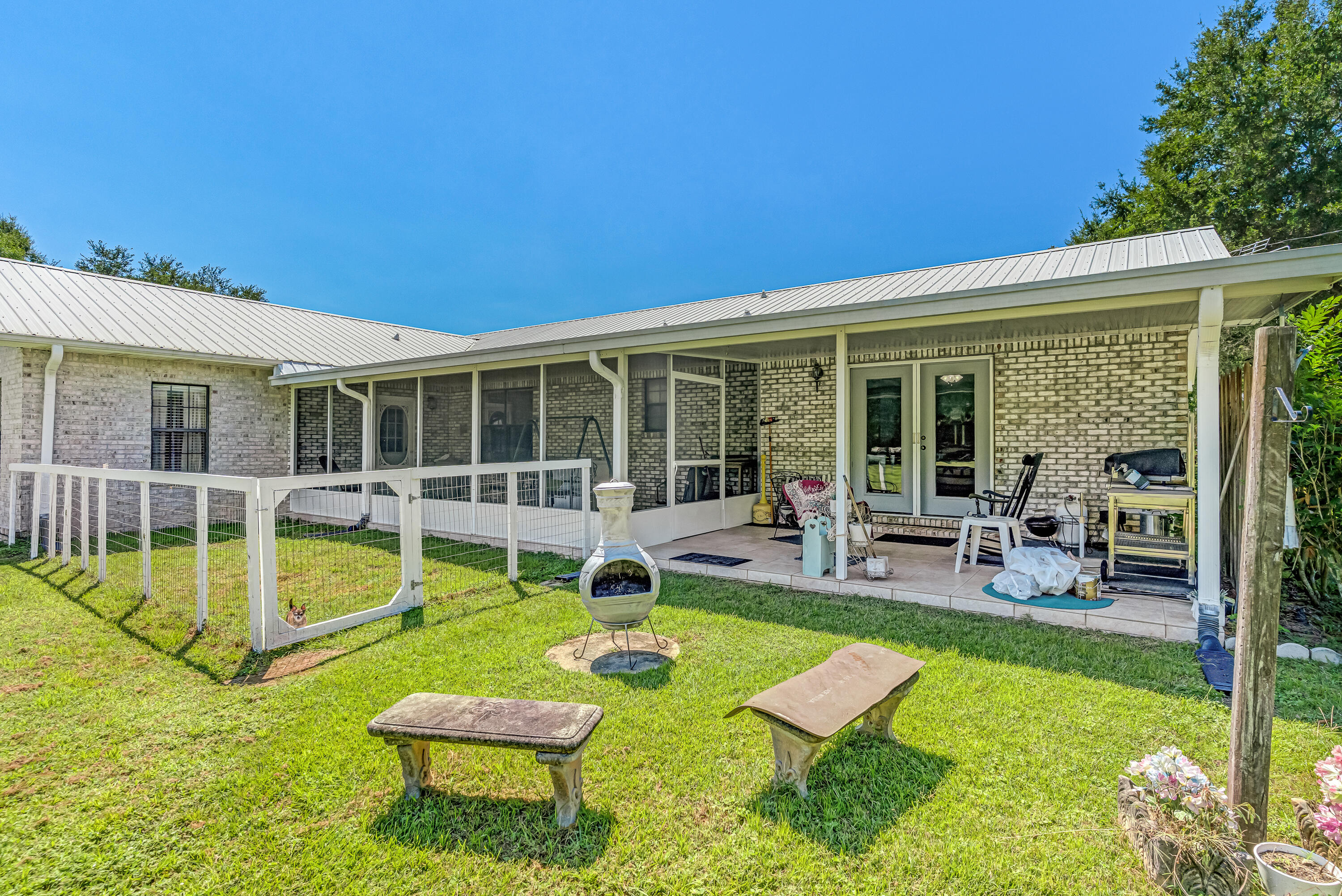 1401 Greenwood Road Baker, FL 32531 - Photo 40 of 61 a view of a house with swimming pool lawn chairs and a yard