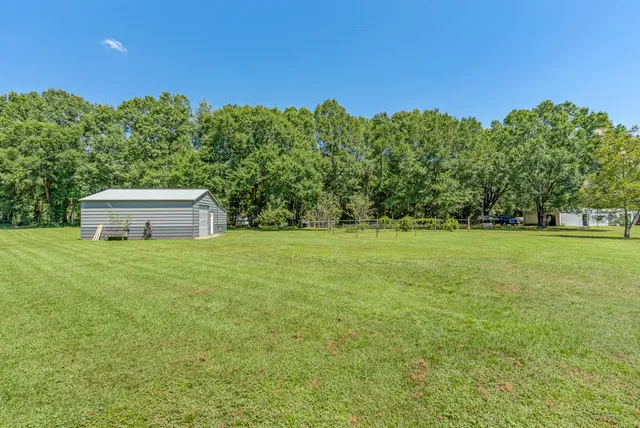 a kitchen with stainless steel appliances granite countertop white cabinets and a sink