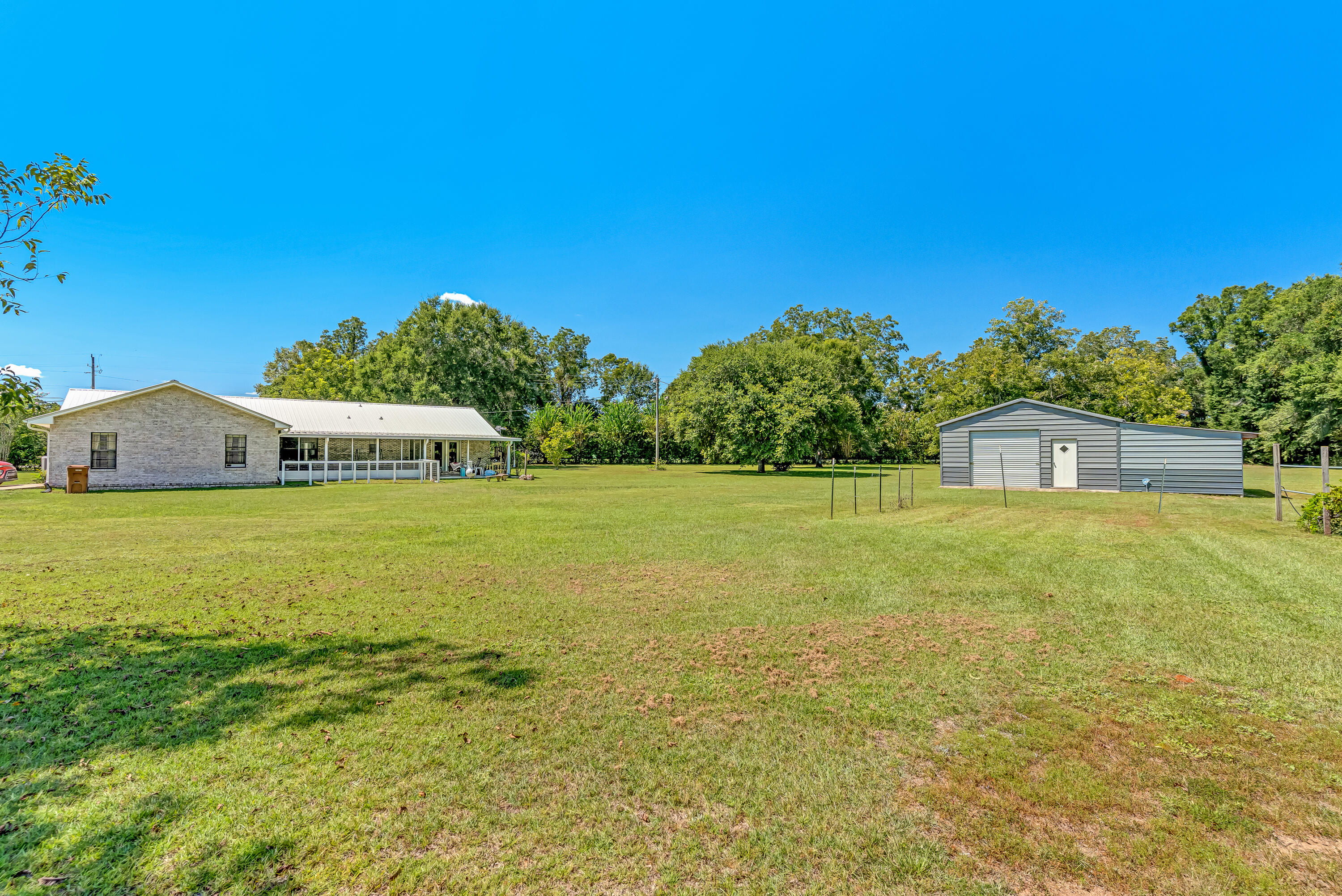 1401 Greenwood Road Baker, FL 32531 - Photo 45 of 61 a view of a big room with swimming pool in front of it