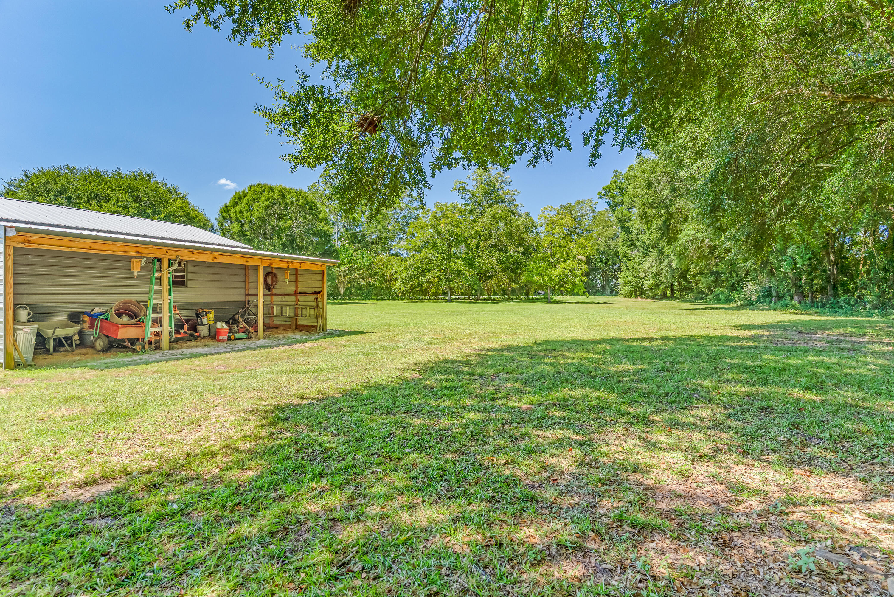 1401 Greenwood Road Baker, FL 32531 - Photo 47 of 61 a front view of a house with a garden