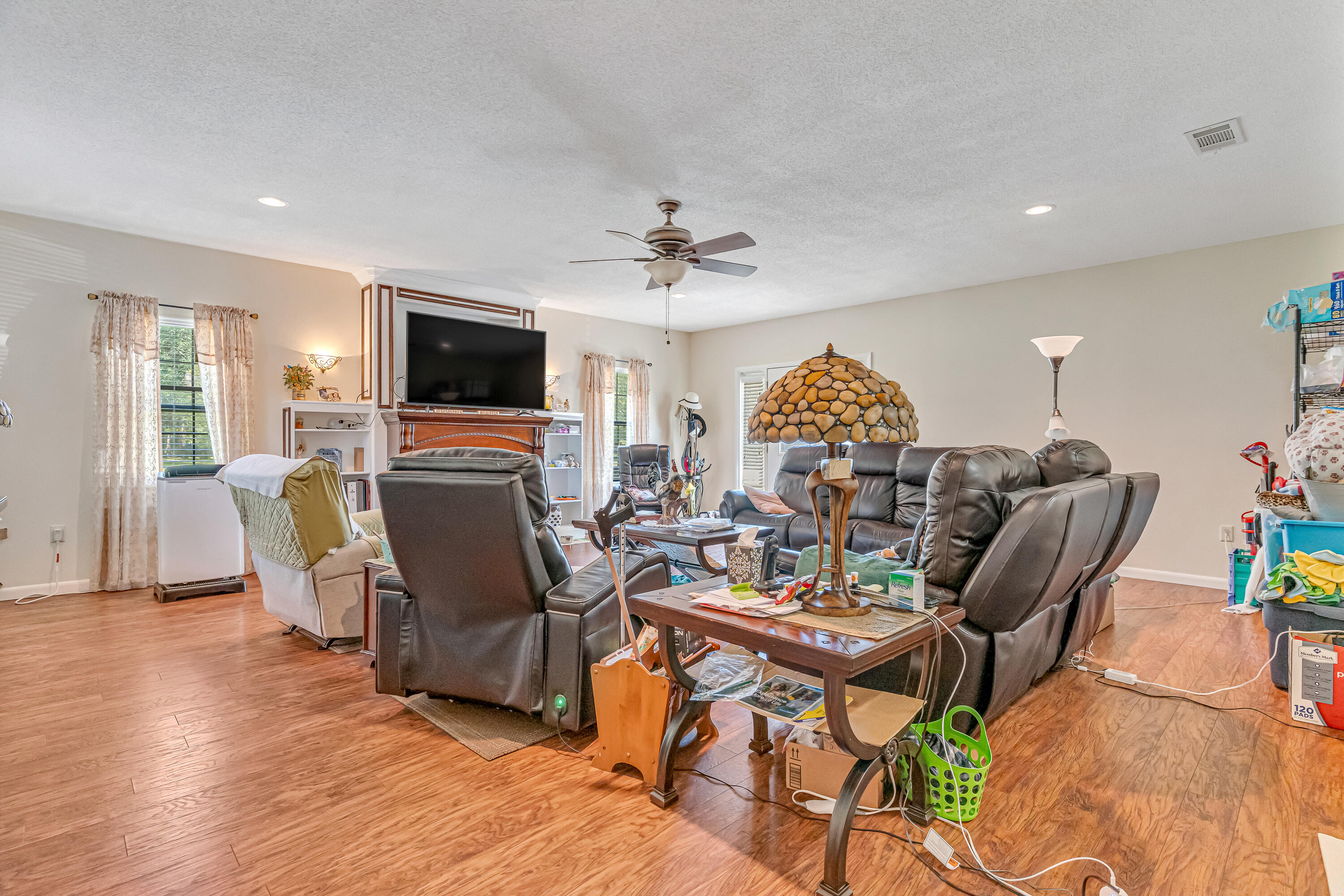 1401 Greenwood Road Baker, FL 32531 - Photo 5 of 61 a living room with furniture a flat screen tv and a fireplace