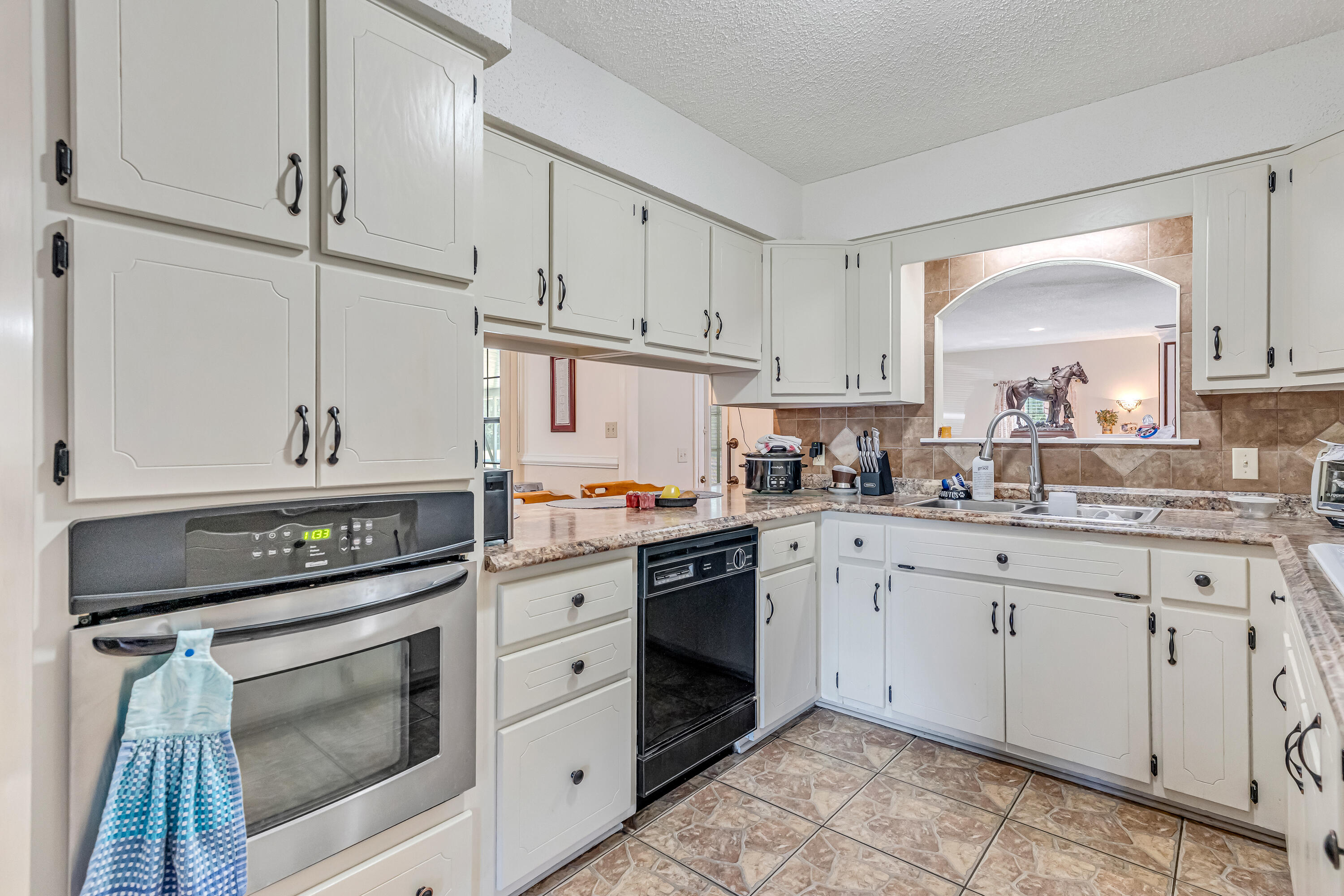 1401 Greenwood Road Baker, FL 32531 - Photo 52 of 61 a kitchen with granite countertop white cabinets and white appliances