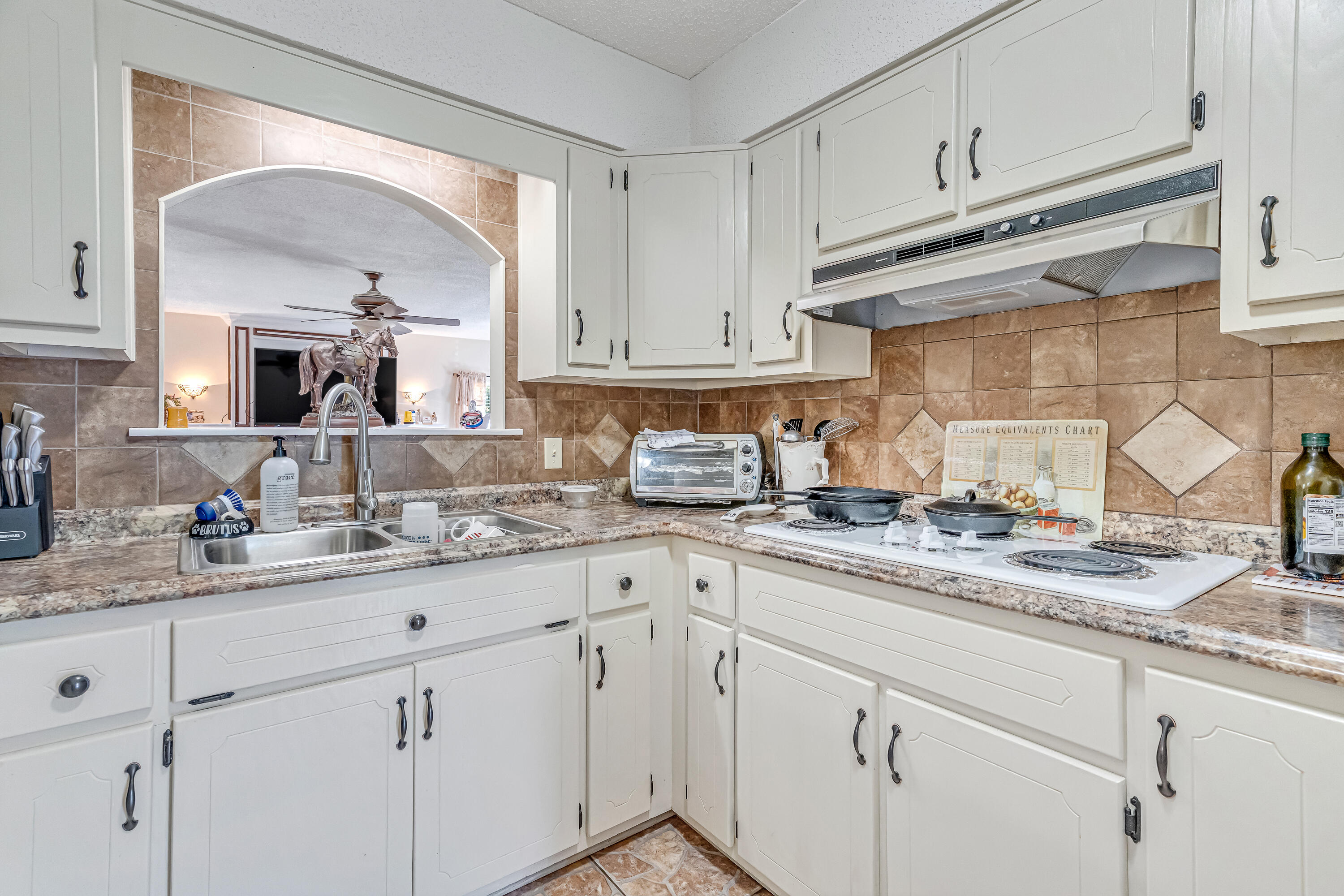 1401 Greenwood Road Baker, FL 32531 - Photo 53 of 61 a kitchen with granite countertop white cabinets and white appliances