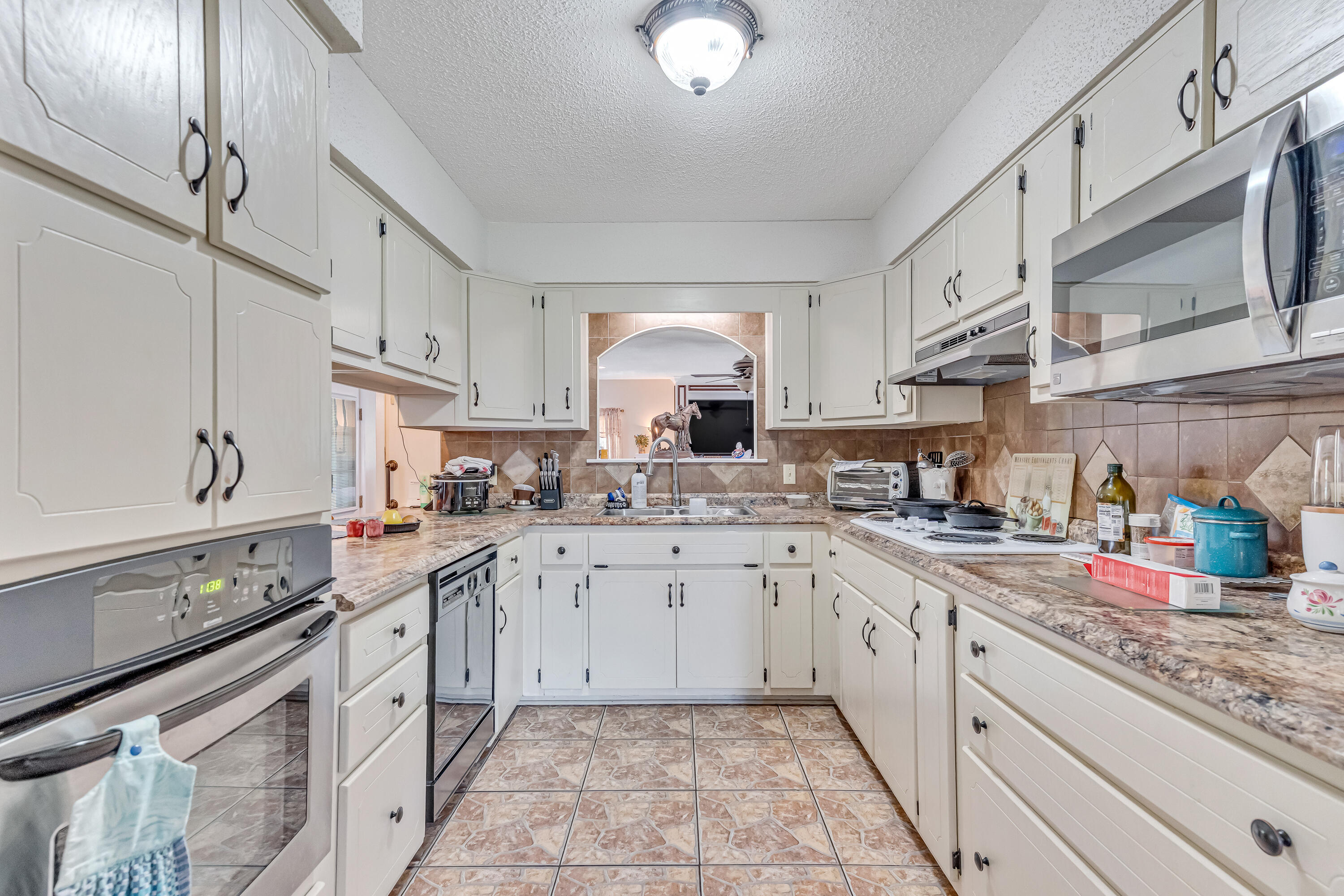 1401 Greenwood Road Baker, FL 32531 - Photo 59 of 61 a kitchen with granite countertop cabinets stainless steel appliances a sink and a counter top space
