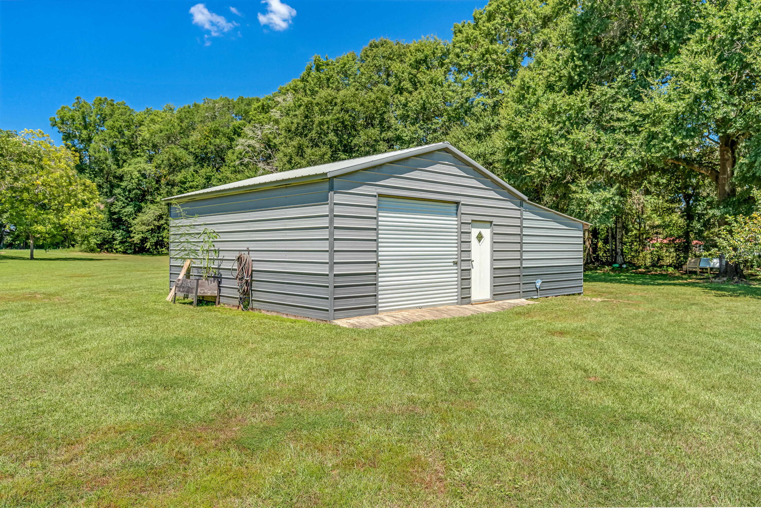 1401 Greenwood Road Baker, FL 32531 - Photo 6 of 61 a view of a backyard with a garden