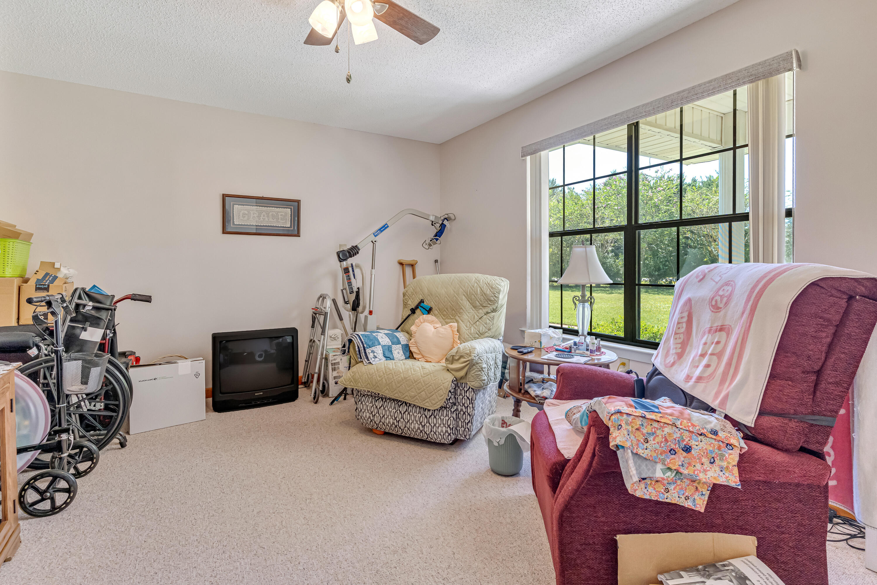 1401 Greenwood Road Baker, FL 32531 - Photo 9 of 61 a living room with furniture a chandelier and a window