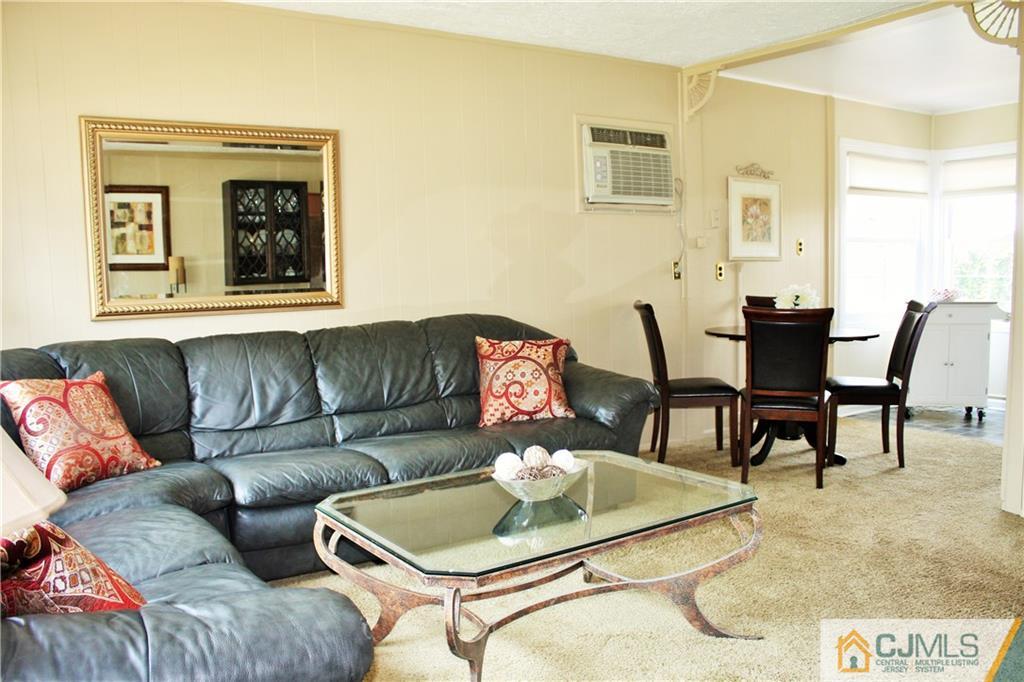 27 Ashley Road Edison, NJ 08817 - Photo 2 of 21 a living room with furniture and a potted plant